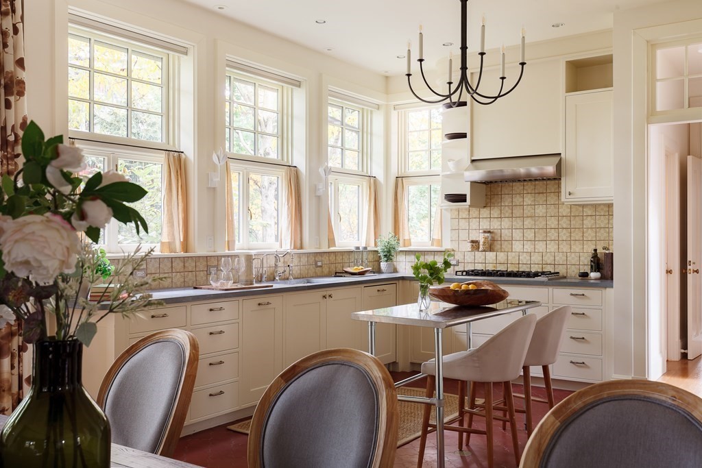 11 Hemlock Road Cambridge, MA 02138 - Photo 11 of 35 a kitchen with a table chairs a sink a stove and a window