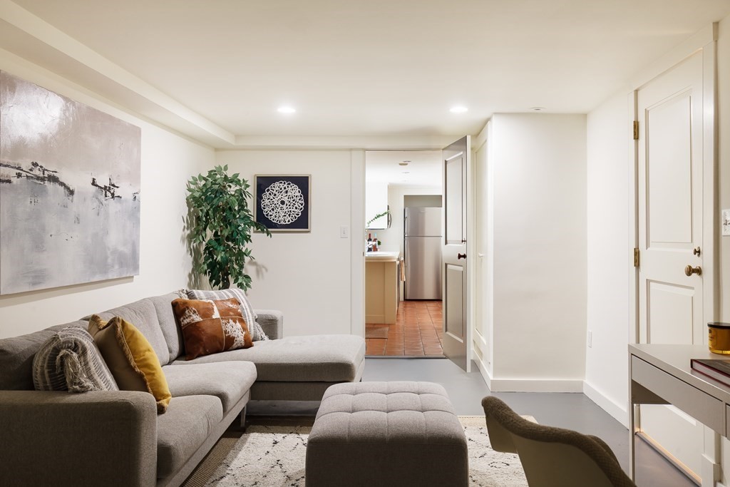 11 Hemlock Road Cambridge, MA 02138 - Photo 29 of 35 a living room with furniture and a glass door shower