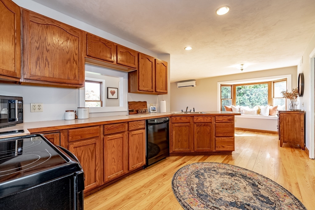162 Chestnut Plain Road Whately, MA 01093 - Photo 20 of 42 a kitchen with stainless steel appliances granite countertop a stove a sink dishwasher and a microwave oven with white cabinets