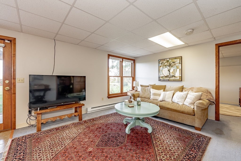 162 Chestnut Plain Road Whately, MA 01093 - Photo 30 of 42 a living room with furniture and a flat screen tv