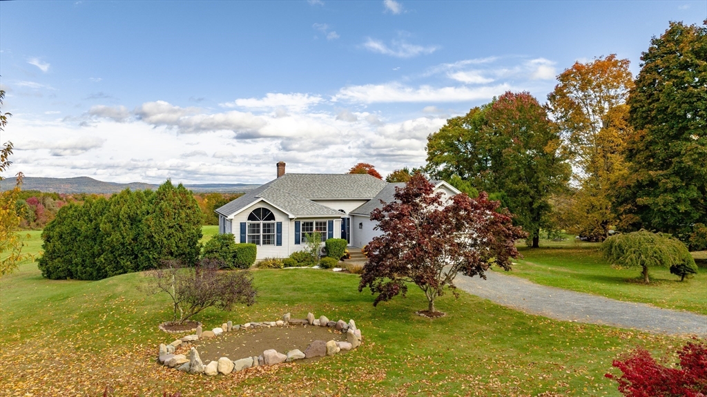162 Chestnut Plain Road Whately, MA 01093 - Photo 42 of 42 a view of a house with a big yard and large trees