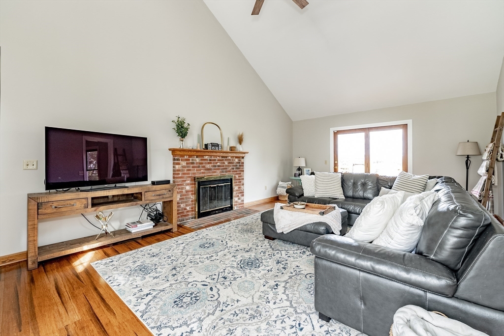 162 Chestnut Plain Road Whately, MA 01093 - Photo 8 of 42 a living room with furniture a flat screen tv and a fireplace