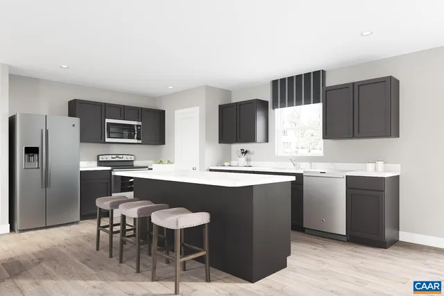 a kitchen with kitchen island a sink cabinets and stainless steel appliances
