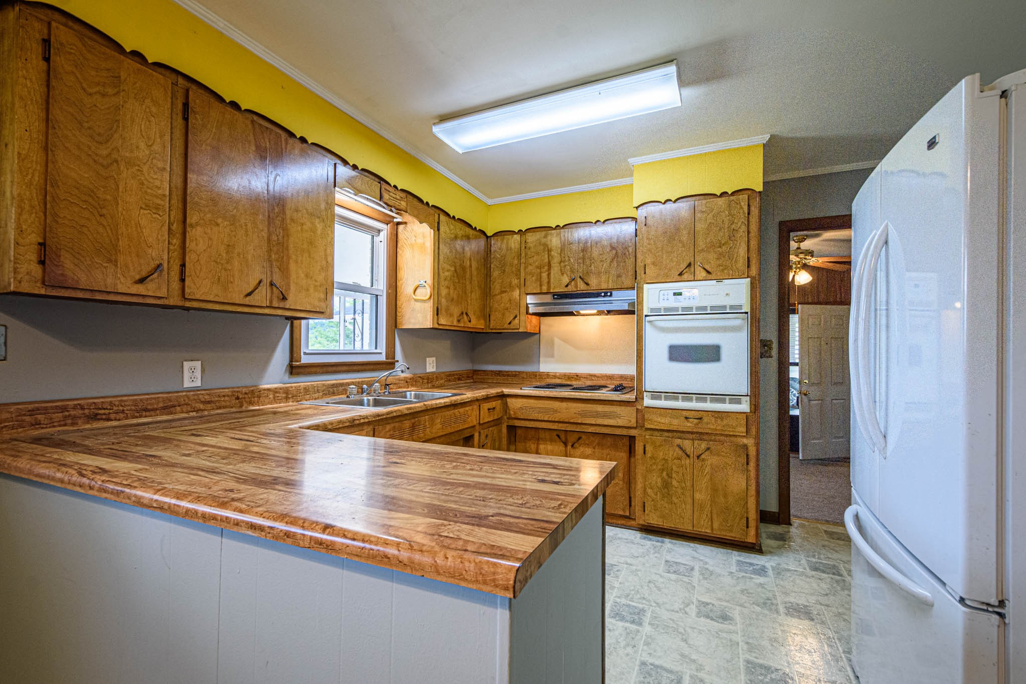 657 Prospect Road Pulaski, TN 38478 - Photo 23 of 50 a kitchen with stainless steel appliances granite countertop a sink a stove and a refrigerator