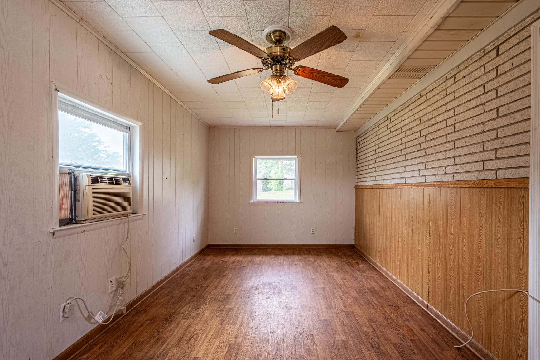 657 Prospect Road Pulaski, TN 38478 - Photo 38 of 50 an empty room with wooden floor chandelier fan and windows