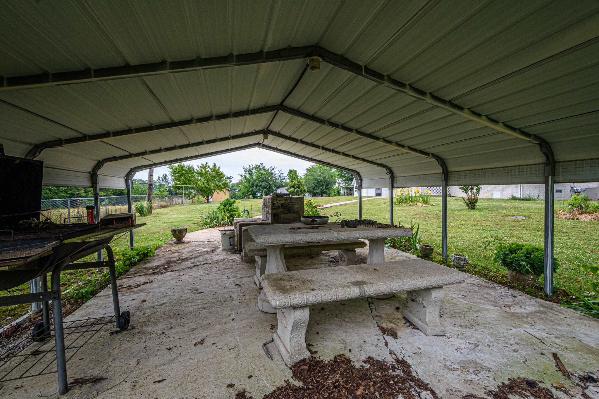 657 Prospect Road Pulaski, TN 38478 - Photo 48 of 50 a view of a patio with table and chairs under an umbrella