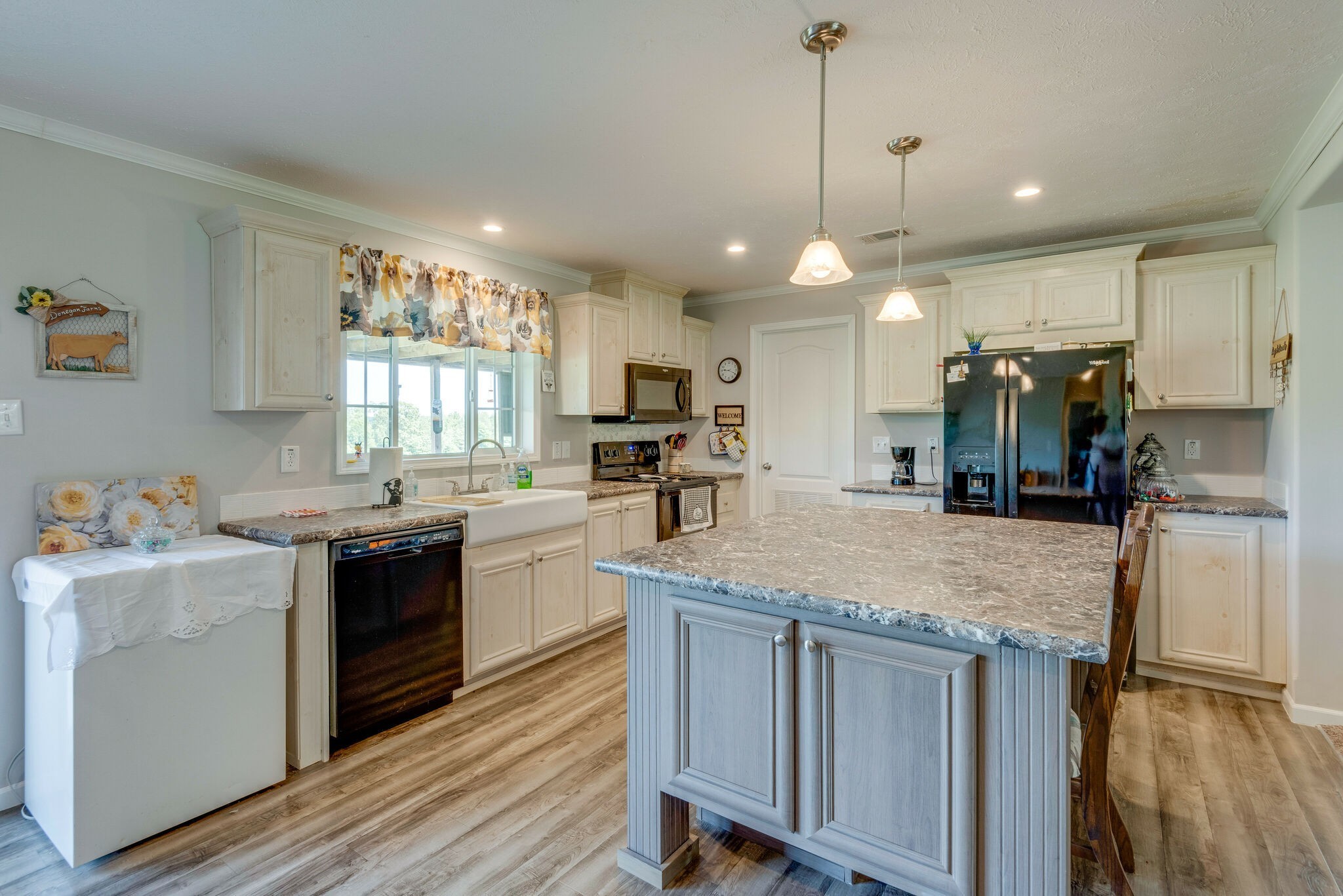 4585 West Tennessee City Road McEwen, TN 37101 - Photo 22 of 55 a kitchen with kitchen island a counter top space a sink stainless steel appliances and a window