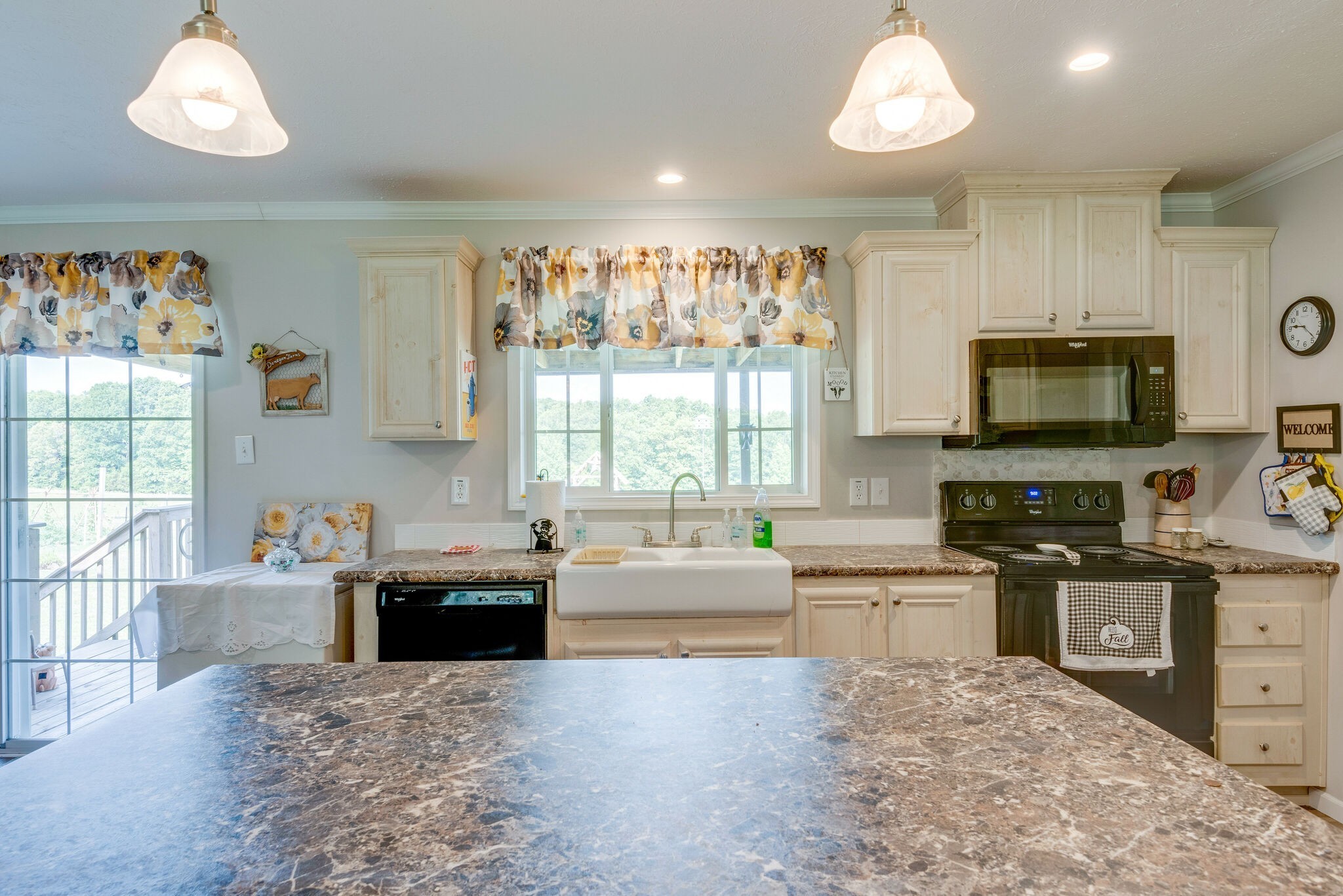 4585 West Tennessee City Road McEwen, TN 37101 - Photo 27 of 55 a large white kitchen with granite countertop a stove a sink a window and dining table
