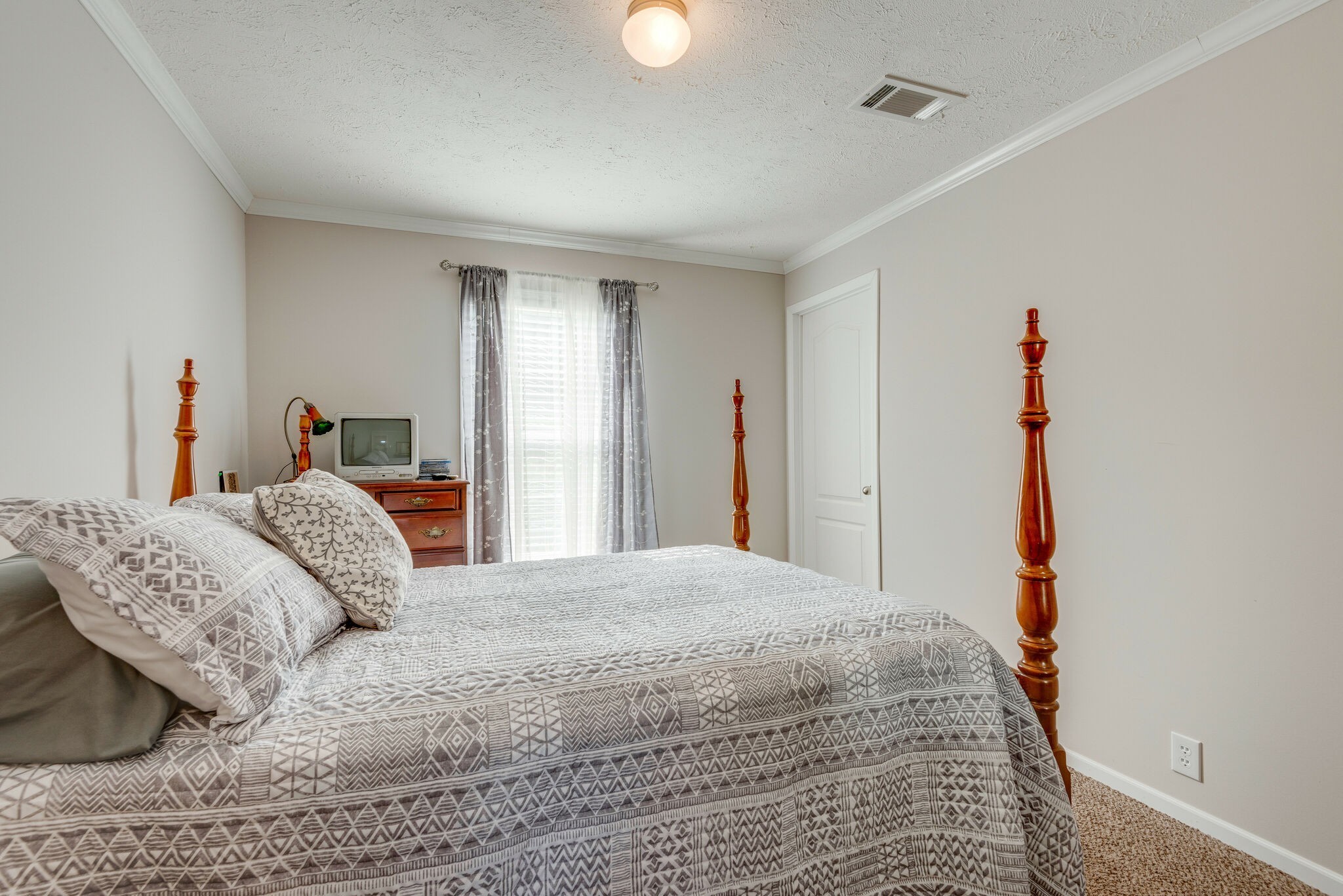 4585 West Tennessee City Road McEwen, TN 37101 - Photo 32 of 55 a bedroom with a bed and a lamp