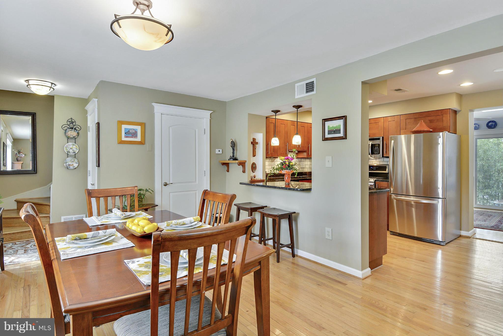 1021 Carson Street Silver Spring, MD 20901 - Photo 13 of 26 a view of a dining room with furniture wooden floor and a chandelier