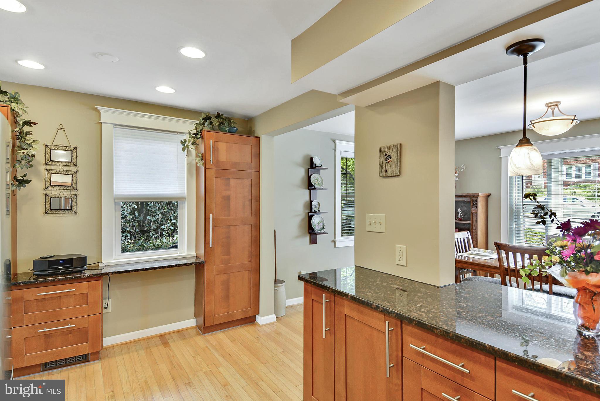 1021 Carson Street Silver Spring, MD 20901 - Photo 16 of 26 a kitchen with granite countertop wooden floors and granite counter tops