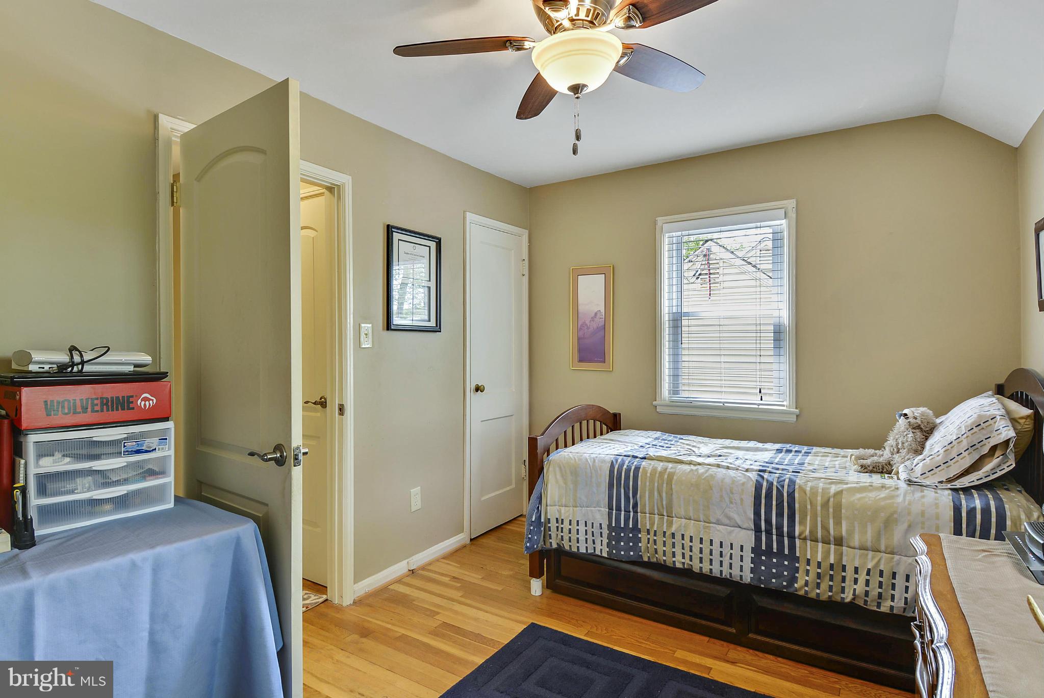1021 Carson Street Silver Spring, MD 20901 - Photo 18 of 26 a bedroom with a bed and a chandelier