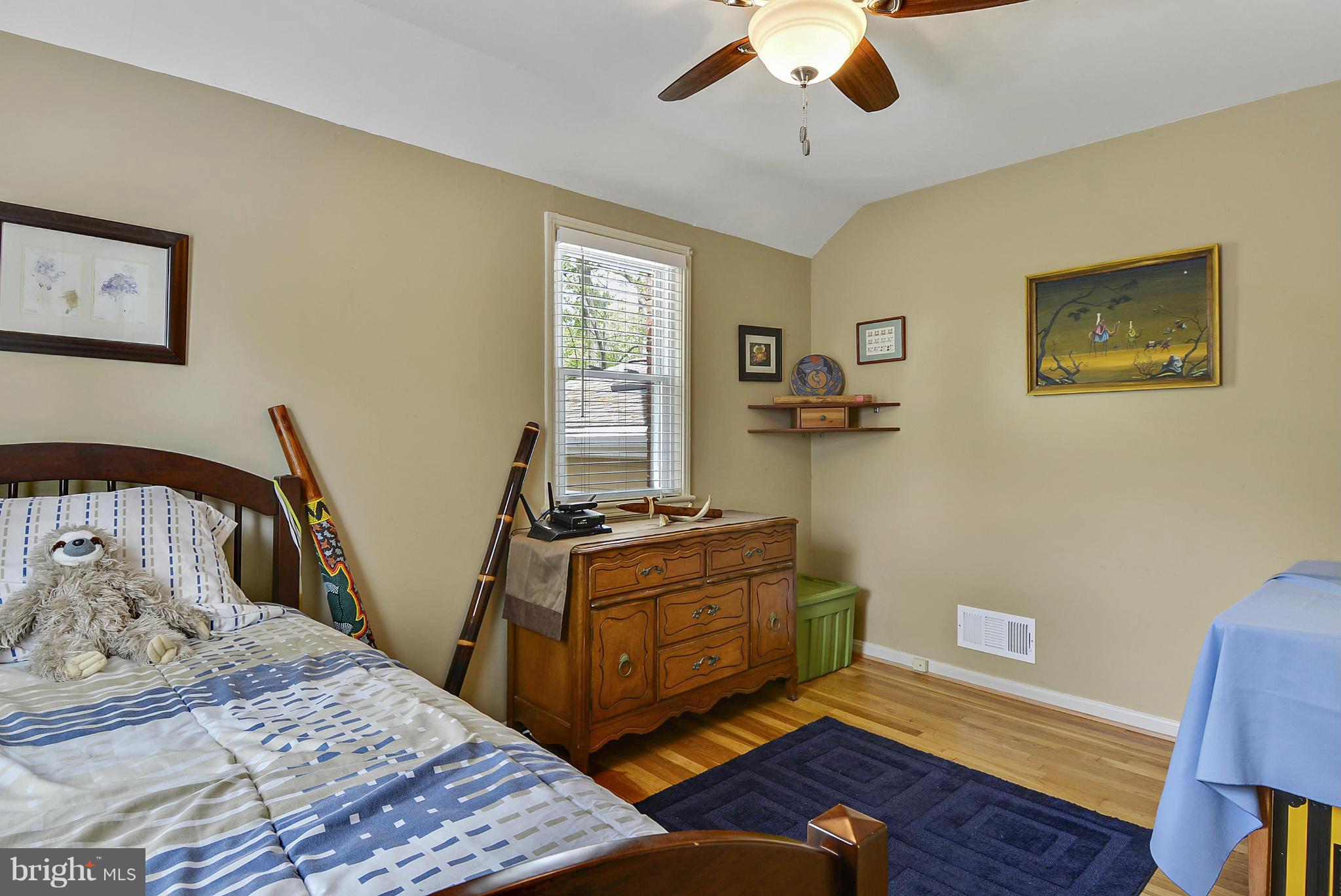 1021 Carson Street Silver Spring, MD 20901 - Photo 19 of 26 a bedroom with a bed and wooden floor