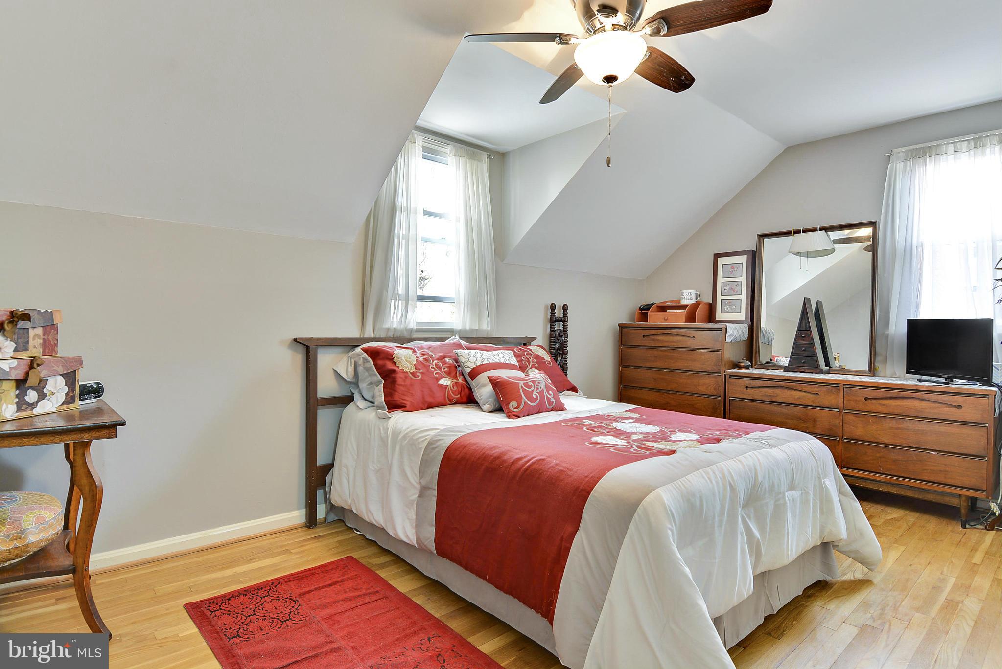 1021 Carson Street Silver Spring, MD 20901 - Photo 20 of 26 a bedroom with a bed and a chandelier