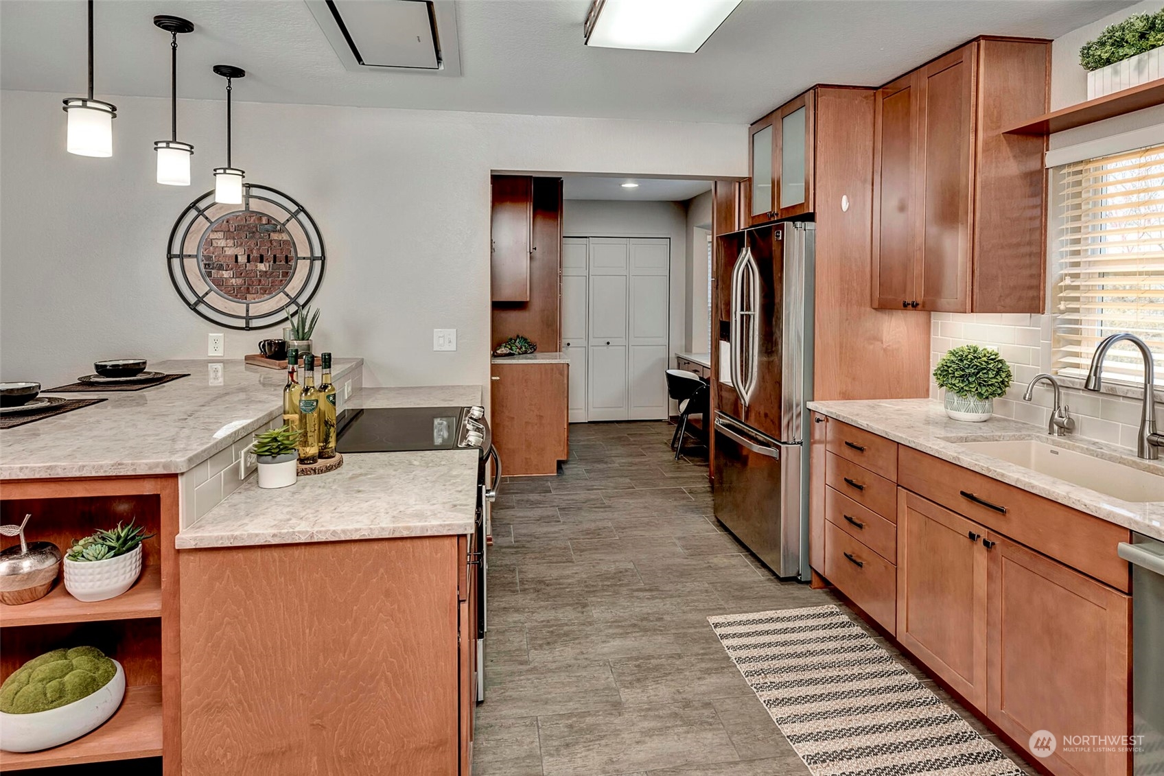 5300 Northeast 16th Street Renton, WA 98059 - Photo 11 of 38 a large kitchen with a large kitchen island wooden cabinets and stainless steel appliances