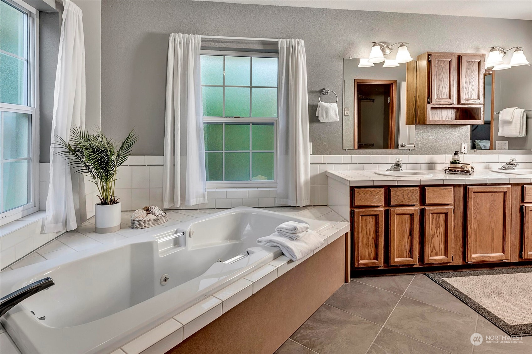 5300 Northeast 16th Street Renton, WA 98059 - Photo 21 of 38 a spacious bathroom with a granite countertop tub sink and mirror