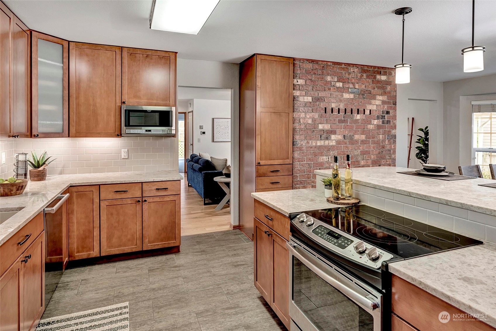 5300 Northeast 16th Street Renton, WA 98059 - Photo 8 of 38 a kitchen with stainless steel appliances granite countertop a stove a sink and a refrigerator