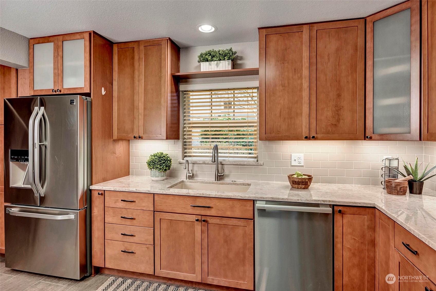 5300 Northeast 16th Street Renton, WA 98059 - Photo 9 of 38 a kitchen with stainless steel appliances a refrigerator sink and cabinets