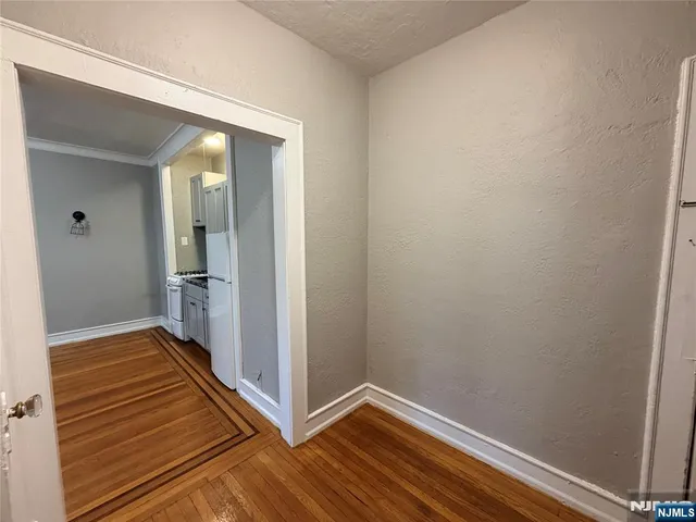 a view of a kitchen with a stove wooden floor and a window