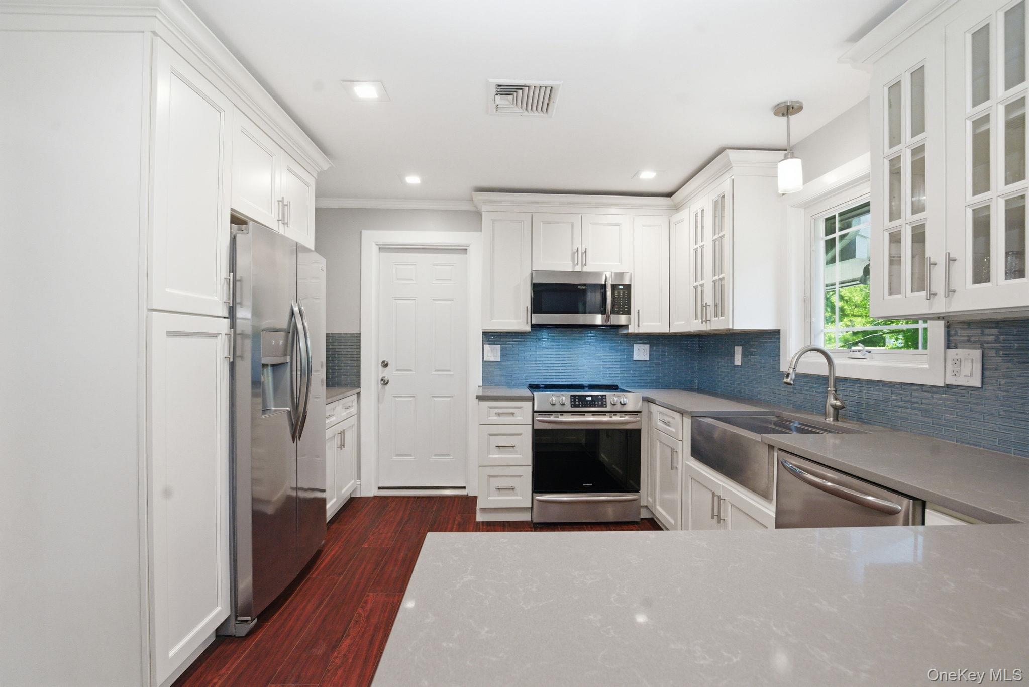 35 Deans Bridge Road Somers, NY 10589 - Photo 7 of 49 Thoughtfully updated from top to bottom, this kitchen blends timeless white cabinetry with sleek quartz and stainless.