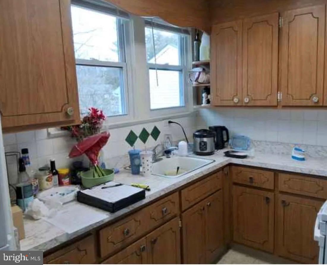 303 Ellis Street Glassboro, NJ 08028 - Photo 3 of 10 a kitchen with stainless steel appliances sink refrigerator and window