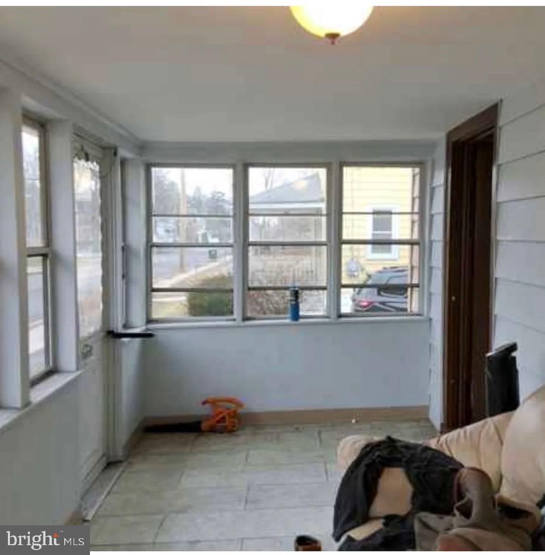 303 Ellis Street Glassboro, NJ 08028 - Photo 4 of 10 a living room with a bed furniture and a large window