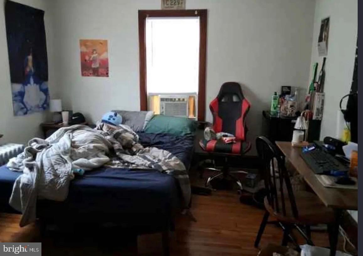 303 Ellis Street Glassboro, NJ 08028 - Photo 8 of 10 a bedroom with a bed table chair and a window
