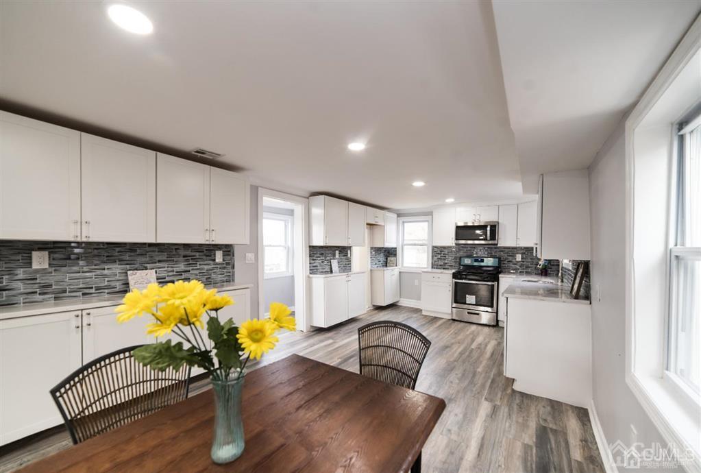 8 Main Street Matawan, NJ 07747 - Photo 13 of 36 a living room with furniture and kitchen view