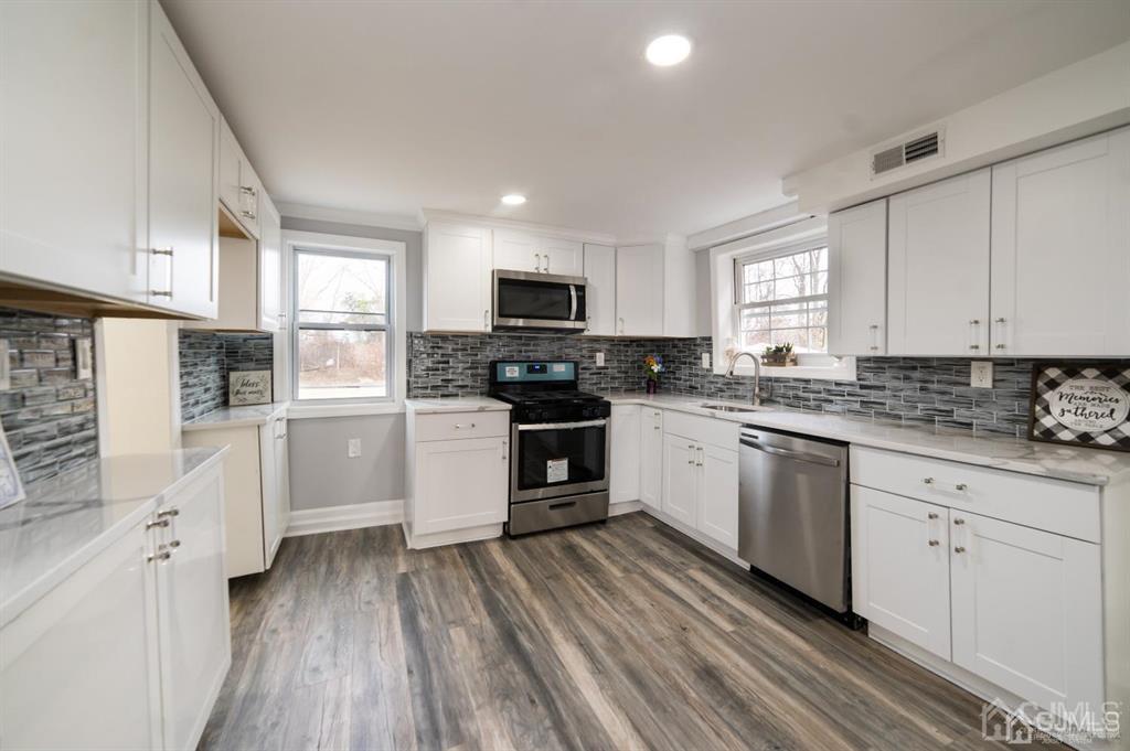 8 Main Street Matawan, NJ 07747 - Photo 14 of 36 a kitchen with granite countertop white cabinets and white appliances