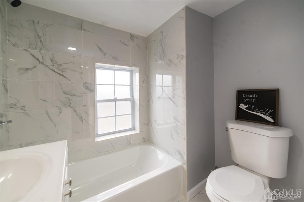 8 Main Street Matawan, NJ 07747 - Photo 19 of 36 a white toilet sitting next to a bath tub