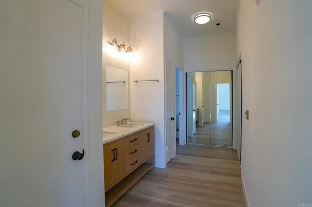 a bathroom with a double vanity sink and mirror