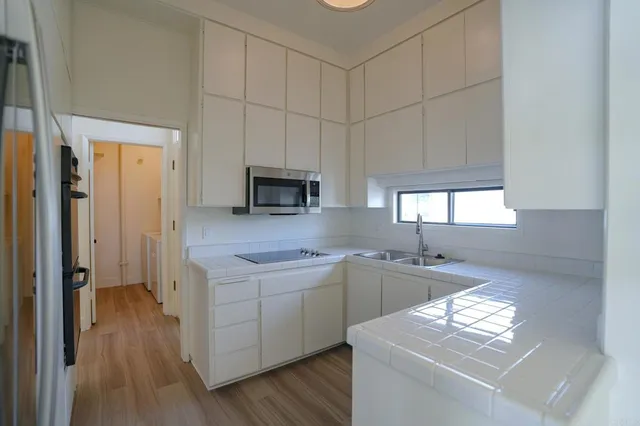a kitchen with a sink stove and cabinets