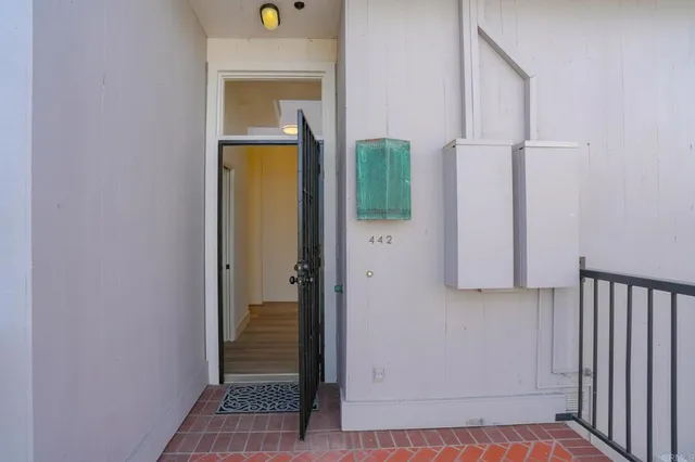 a view of a hallway with wooden floor and closet
