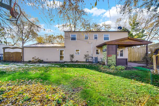 a view of a house with backyard and sitting area