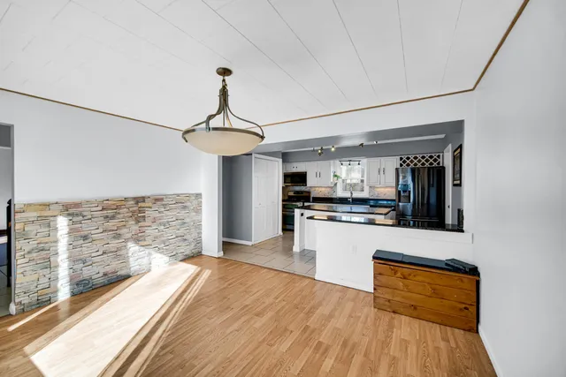 a kitchen with stainless steel appliances granite countertop a refrigerator and a stove top oven