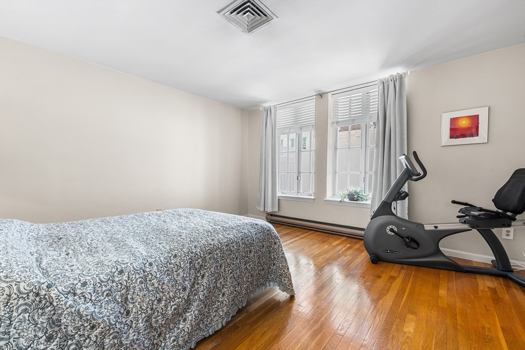 63 Garden Road, Unit C5 Wellesley, MA 02481 - Photo 14 of 30 a bedroom with a bed and wooden floor