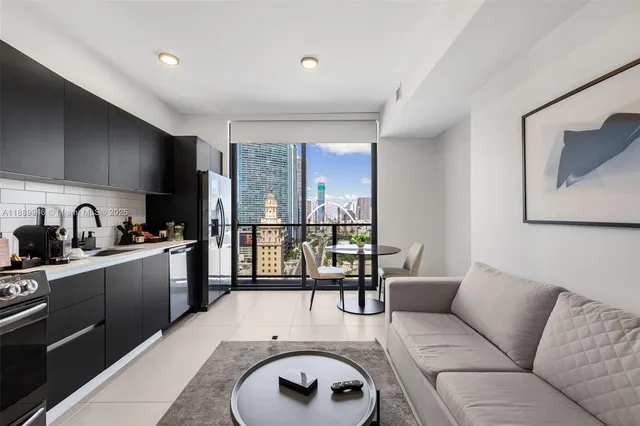 a living room with furniture and a kitchen