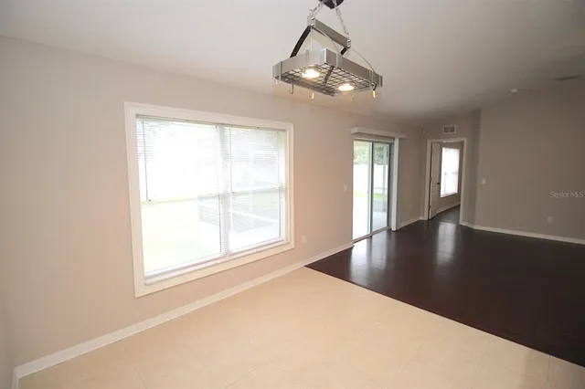 a view of a livingroom with a ceiling fan and window