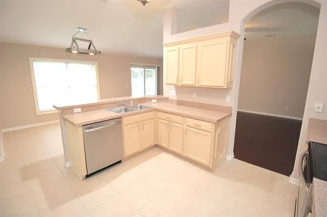 a kitchen with white cabinets sink and white appliances