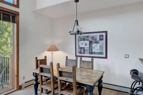 a view of a dining room with a table and chairs