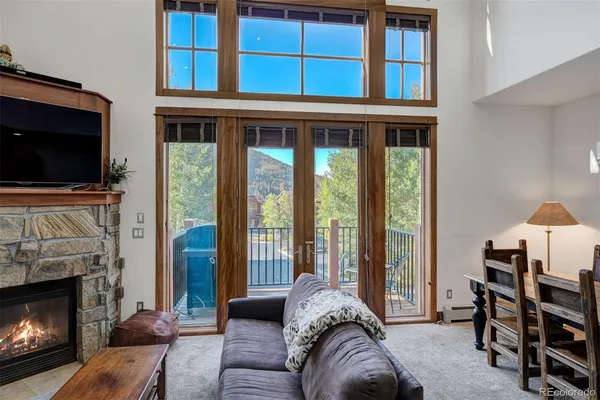 a living room with furniture a flat screen tv and a fireplace