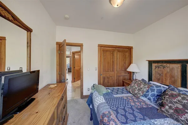 a bedroom with furniture and a flat screen tv