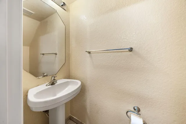 an empty room with window and chandelier fan