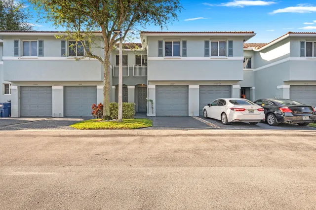 an aerial view of house with yard and ocean view