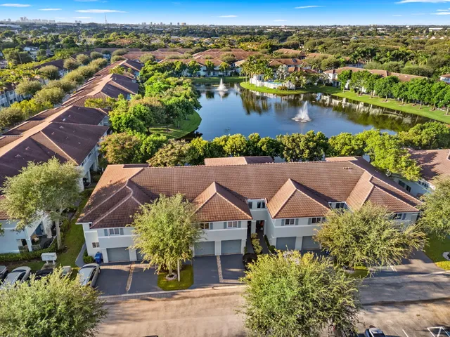 an aerial view of residential houses with outdoor space and river