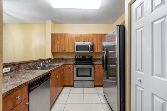 a kitchen with stainless steel appliances granite countertop a sink and stove top oven