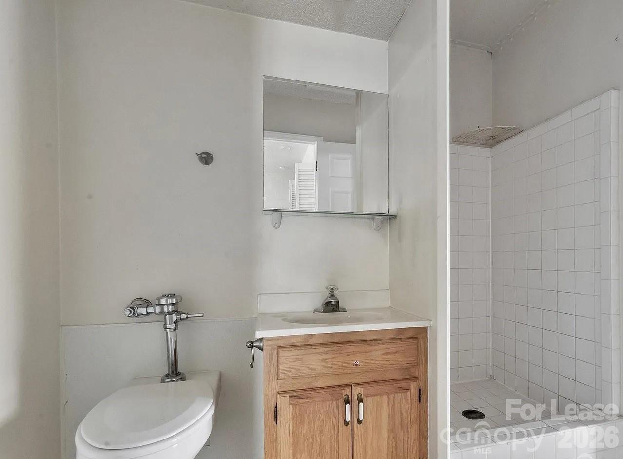 203 West Liberty Street, Unit PH York, SC 29745 - Photo 6 of 10 a bathroom with a toilet sink and shower
