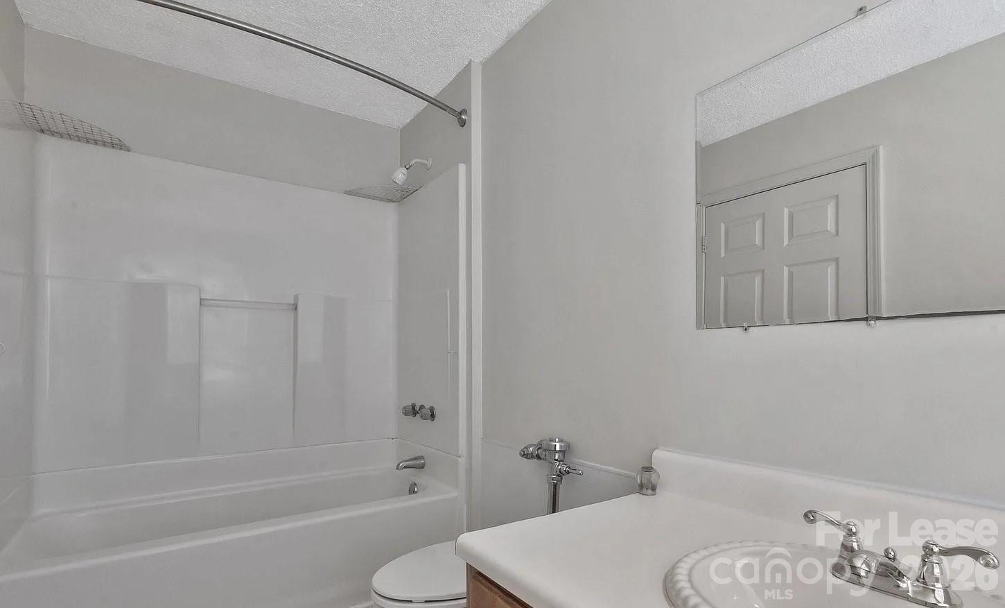 203 West Liberty Street, Unit PH York, SC 29745 - Photo 7 of 10 a bathroom with a sink and a mirror