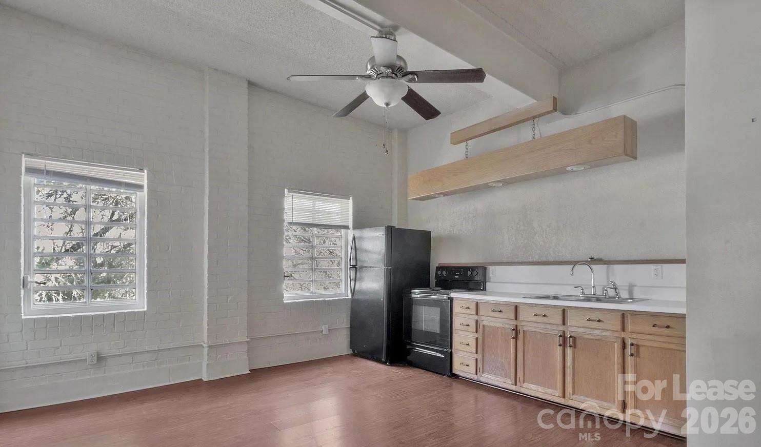 203 West Liberty Street, Unit PH York, SC 29745 - Photo 8 of 10 a kitchen with cabinets appliances a sink and a window