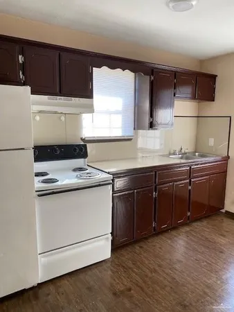 a kitchen with stainless steel appliances granite countertop a sink and a stove